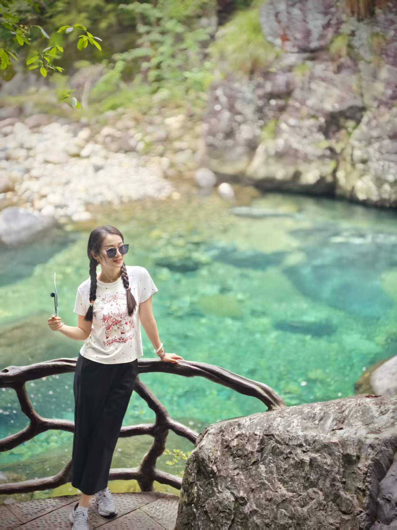 Traveler standing before clear turquoise canyon water